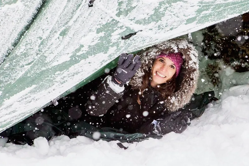 Ragazza dentro a rifugio di sopravvivenza sotto la neve