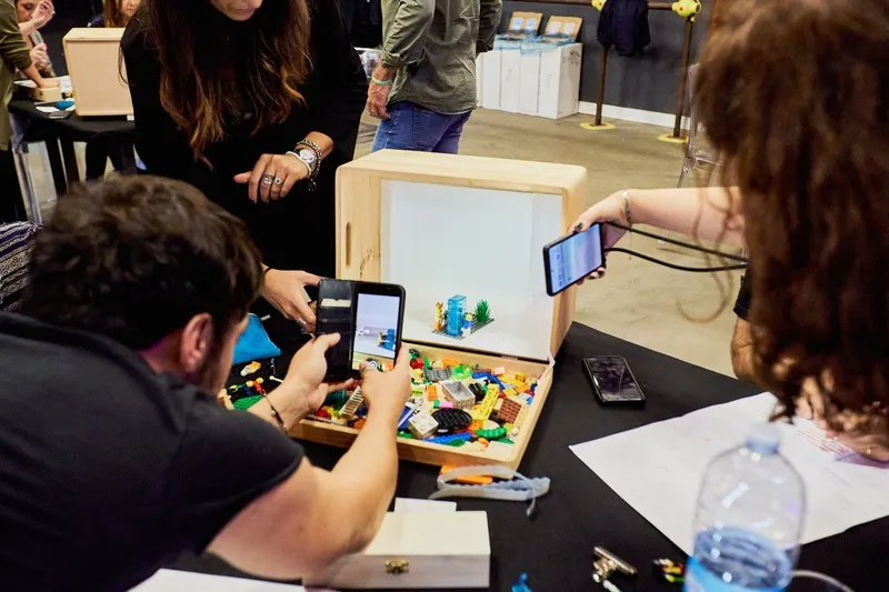 People playing with LEGO   in a box during a team building