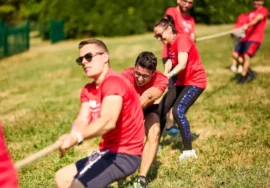 team di colleghi che fa tiro alla fune durante un team building